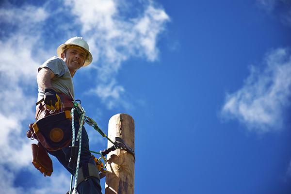 Powerline worker with blue sky background
